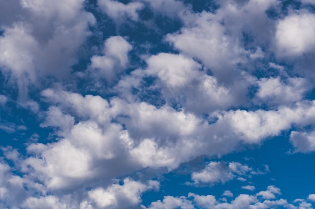 Stunning view of a clear blue sky filled with fluffy white clouds on a bright summer day.