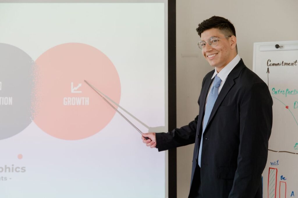 Smiling businessman presenting growth strategy in a modern meeting room.